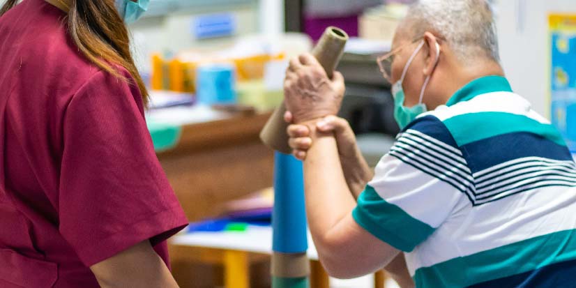 man working on physical therapy with specialist